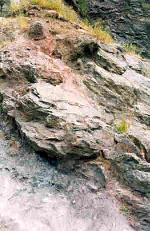 Photograph Four. The unconformity exposed at Gullet Quarry. The Precambrian igneous rocks could have represented seas stacks in front of an eroded cliff line.