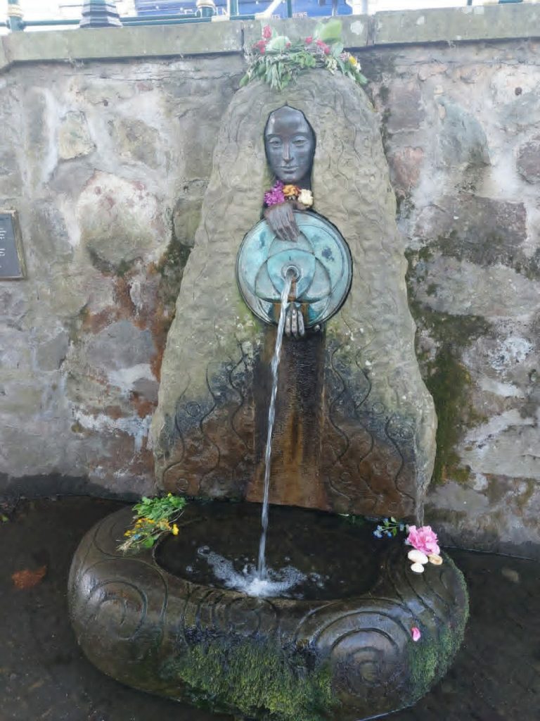 Malvhina with offerings of flowers and shells, before being dressed