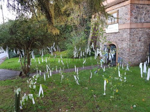 2022 All Souls - Remembrance notes tied to trees around the Clock Tower